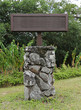 blank wooden sign on lava rock stand
