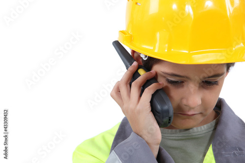 Photo: Young boy pretending to be a construction worker Young boy pretending to be a construction worker