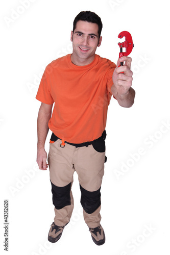 Photo: Man holding a tool Man holding a tool