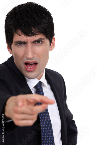 Photo: A boss blaming one of his employee. A boss blaming one of his employee.