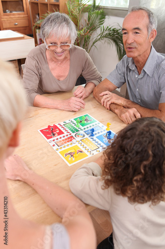 Photo: Family playing board game together Family playing board game together