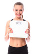 Photo: Beautiful fitness girl holding scales Beautiful fitness girl holding scales