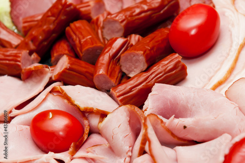 Photo: platter of cold cuts and sausages with ham and tomatoes platter of cold cuts and sausages with ham and tomatoes