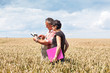 Farmer and agricultural engineer in the field discuss