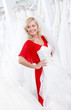 Young girl puts a wedding gown to her body