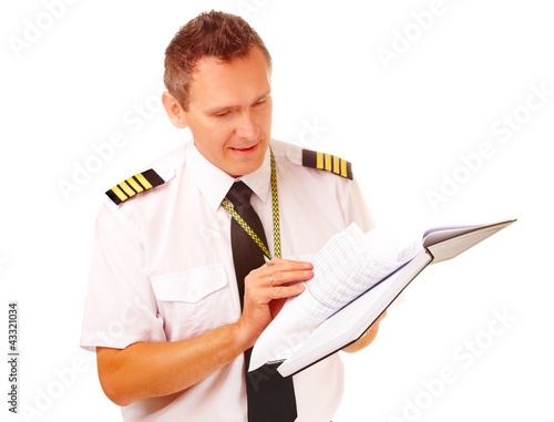 Photo: Airline pilot filling in papers Airline pilot filling in papers