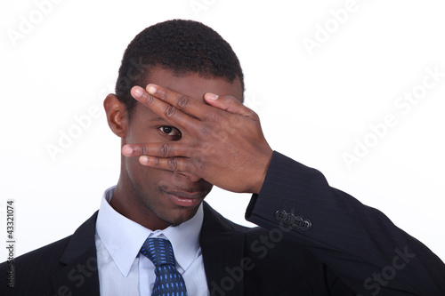 Foto: Businessman covering face with hand Businessman covering face with hand