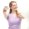 Smiling blonde woman pointing on her ID card