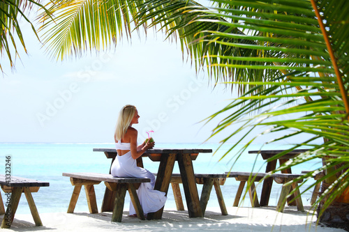 Photo: woman in a tropical cafe woman in a tropical cafe