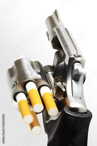 Photo: Revolver with cigarette bullets (clipping path) Revolver with cigarette bullets (clipping path)