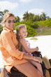 Caucasian mother and daughter riding on horseback