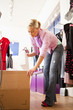 Hispanic business owner unpacking boxes in store
