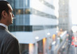 Hispanic businessman looking at city scene