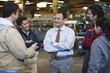Foreman talking workers in factory