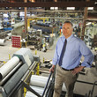 Caucasian foreman standing in factory