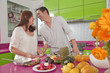 Hispanic couple preparing fruit in kitchen together