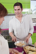 Hispanic couple preparing fruit in kitchen together