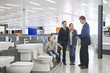 Salesman talking to Hispanic family in bathroom supply store