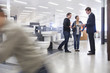 Salesman talking to Hispanic couple in bathroom supply store
