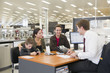 Salesman talking to Hispanic family in home supply store