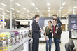 Salesman talking to Hispanic family in appliance department
