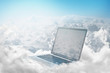 Laptop floating in clouds