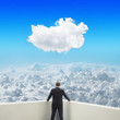 Black businessman on balcony looking at clouds