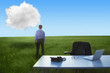 Middle Eastern businessman in field looking at cloud