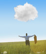 Black businessman in field looking at cloud