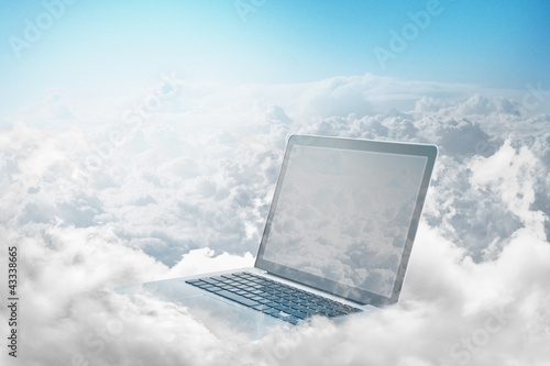 Photo: Laptop floating in clouds Laptop floating in clouds