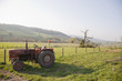 Old-fashioned tractor in farm field