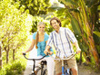 Caucasian couple riding bikes together