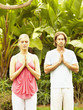 Caucasian couple practicing yoga