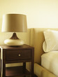 Modern lamp on side table in bedroom