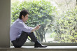 Mixed race businessman text messaging on cell phone