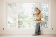 Caucasian carpenter using digital tablet in empty room