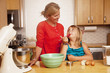 Photo: Caucasian woman baking with daughter in kitchen Caucasian woman baking with daughter in kitchen