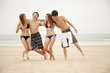 Teenagers hanging out together on beach