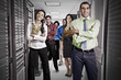 Business people standing together in server room