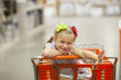 Caucasian girl riding in shopping cart