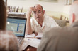 Caucasian restaurant owner working with co-workers in booth