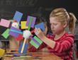Children making paper wind turbines in classroom