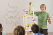 Boy talking about gravity in classroom