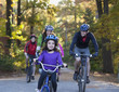 Family riding bicycles in park