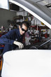 Foto: Hispanic mechanic working on car Hispanic mechanic working on car