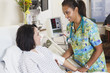 Nurse comforting patient in hospital