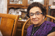 Senior Hispanic woman at dinner table