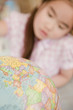 Japanese girl looking at globe