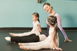 Girls taking ballet lessons from teacher