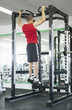 Middle Eastern man exercising in health club